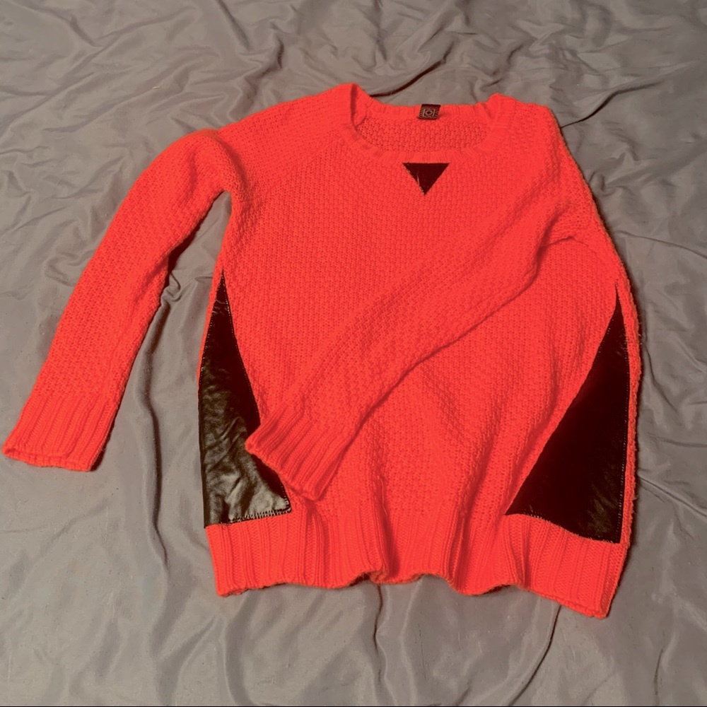 coral sweater with “leather” detailing